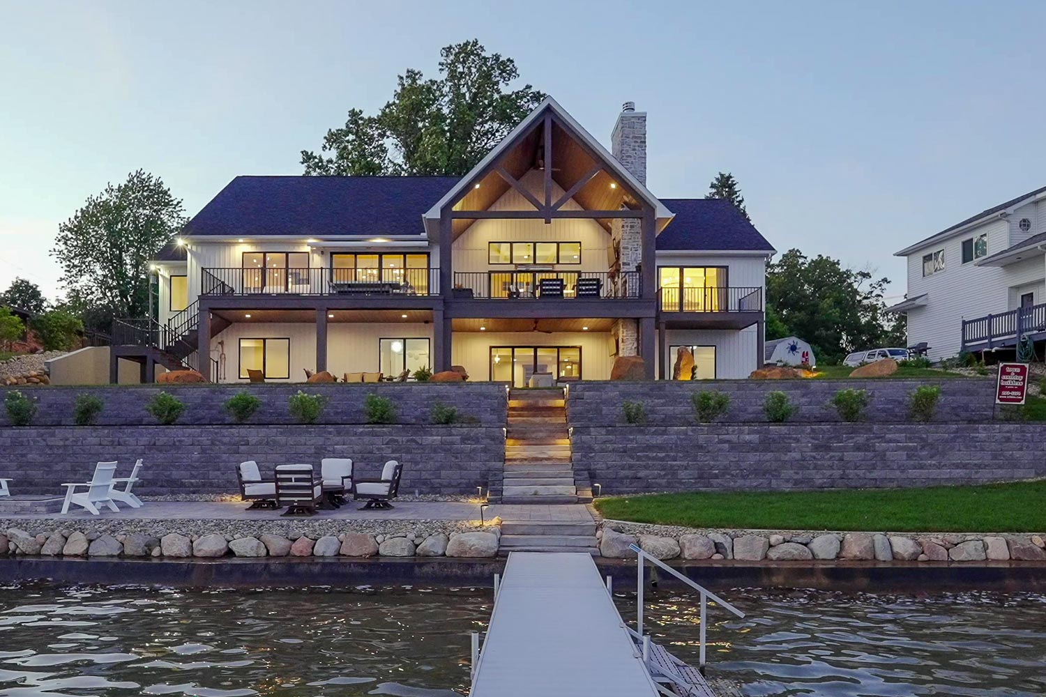 Lakehouse lit up at dusk from the water