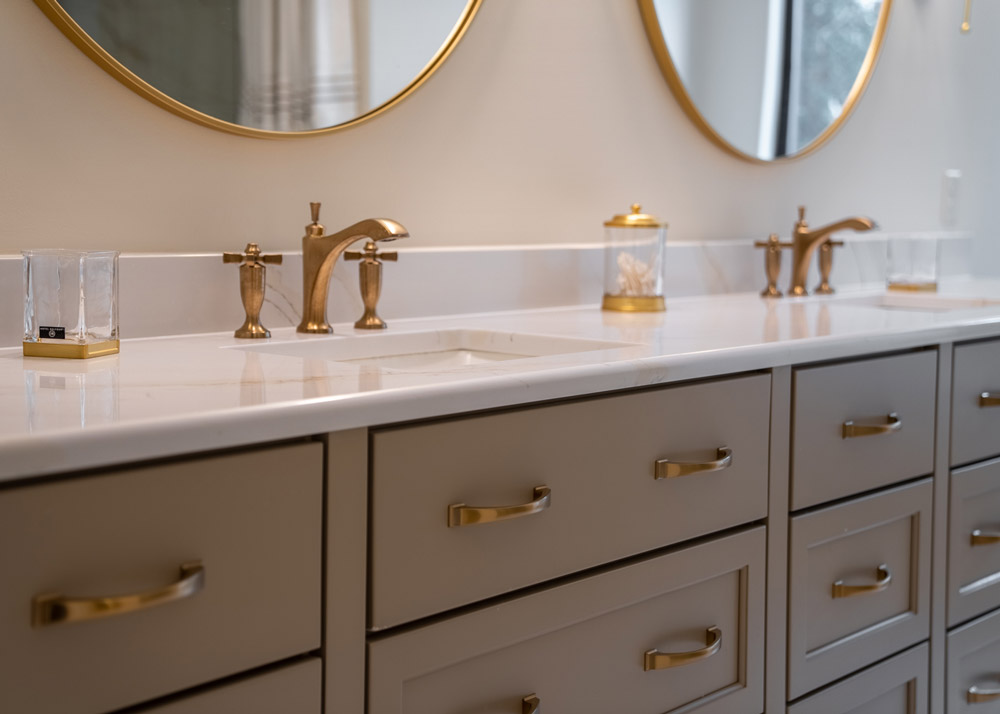 Riverfront Abode's master bathroom double vanity with gold fixtures