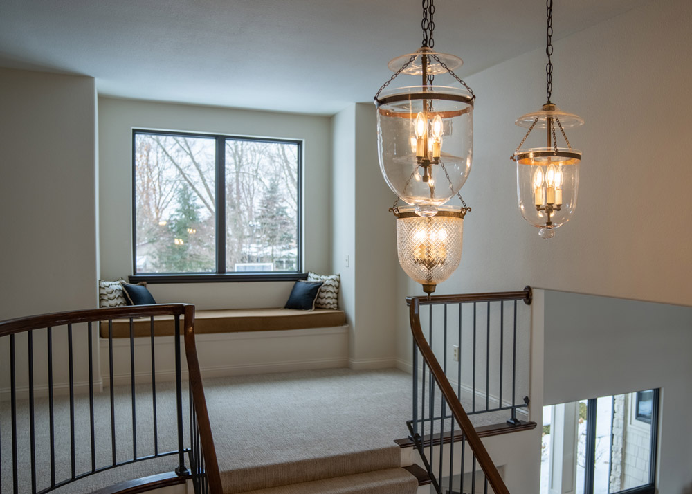 Riverfront Abode's reading nook and chandelier of the grand staircase